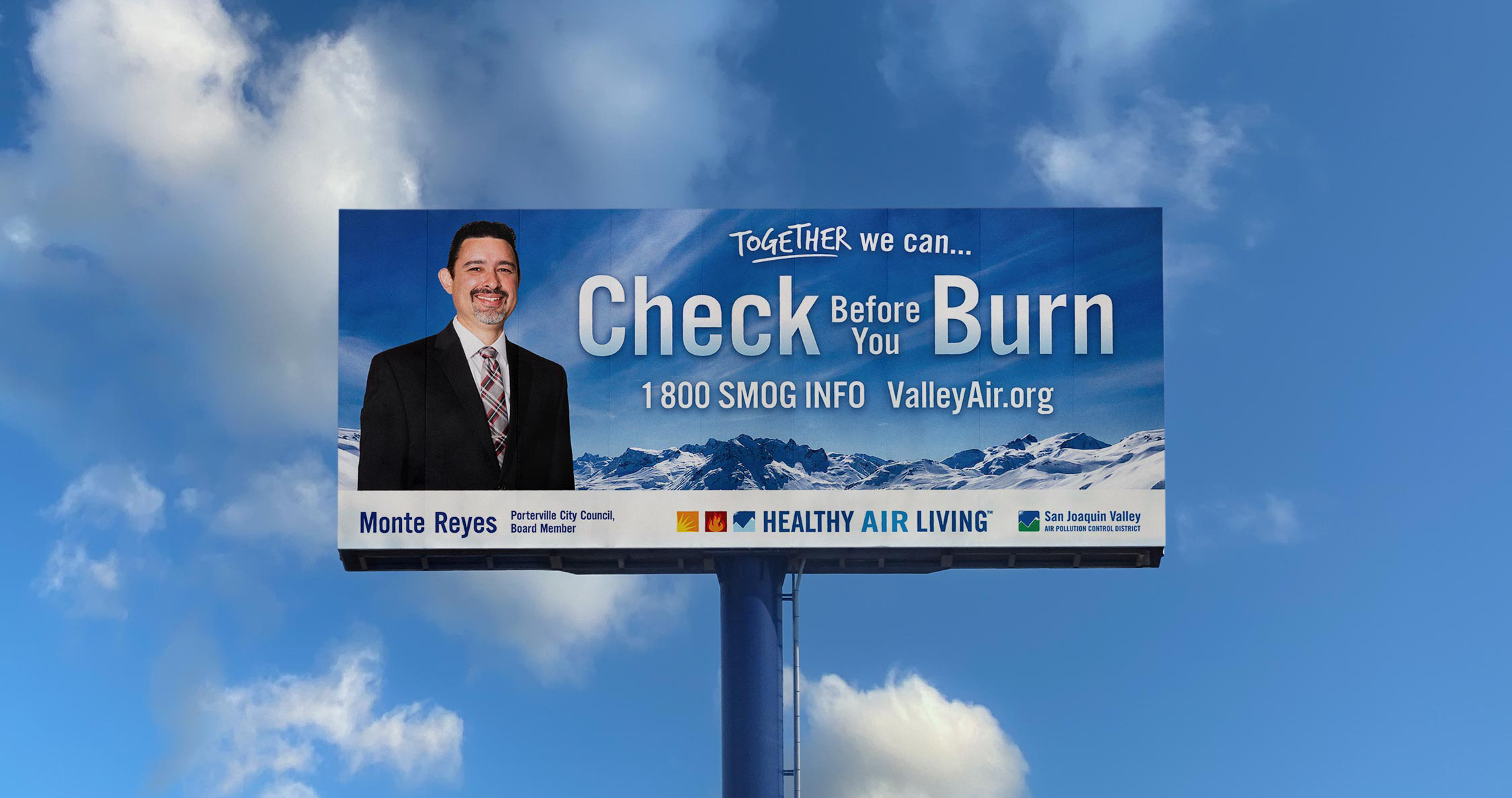 Blue billboard with a partly cloudy sky background promoting Valley Air District's Check Before You Burn campaign with a profile photo of Porterville City Councilmember Monte Reyes